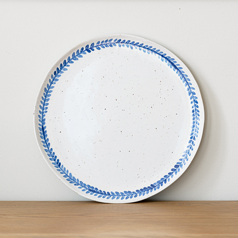 Handmade stoneware dinner plate crafted in Berkshire from smooth speckled clay and finished with a hand-painted cobalt blue rim. Timeless, versatile ceramics for everyday use.