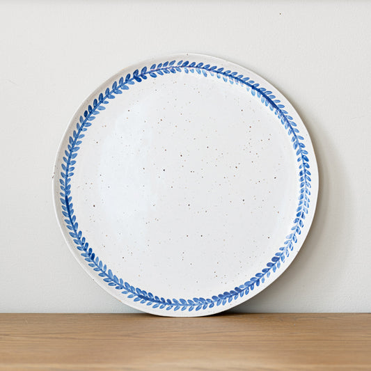 Handmade stoneware dinner plate crafted in Berkshire from smooth speckled clay and finished with a hand-painted cobalt blue rim. Timeless, versatile ceramics for everyday use.