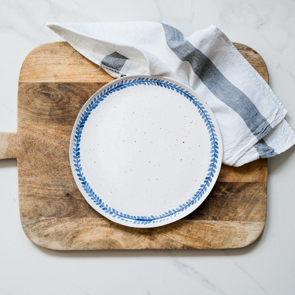 Handmade stoneware dinner plate crafted in Berkshire from smooth speckled clay and finished with a hand-painted cobalt blue rim. Timeless, versatile ceramics for everyday use.