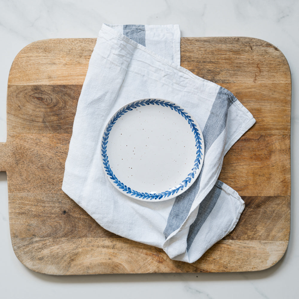 Handmade stoneware small plate crafted in Berkshire from smooth speckled clay and finished with a hand-painted cobalt blue rim. Timeless, versatile ceramics for everyday use.
