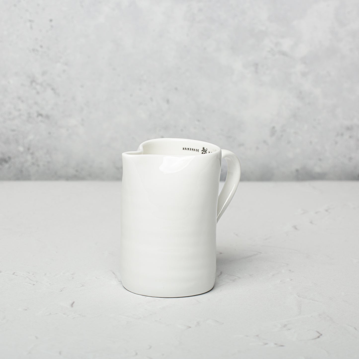 Bone china milk jug by Emma Alington.