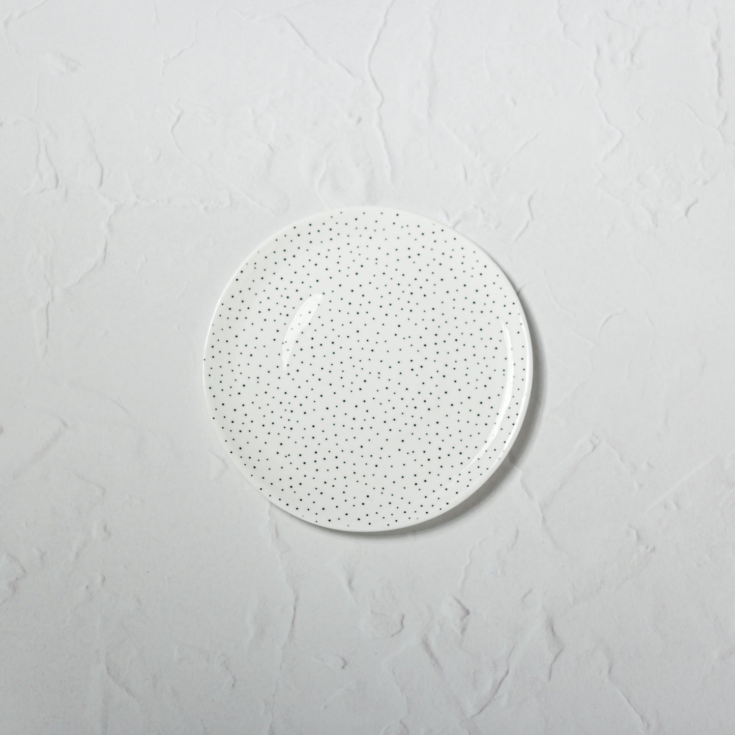 Small bone china plate by Emma Alington with a black dotted pattern.
