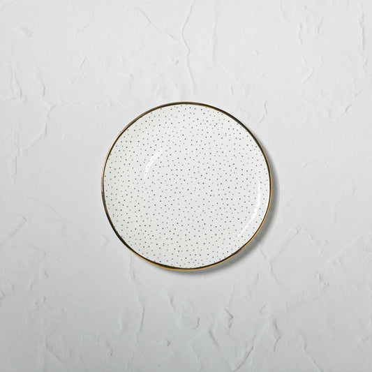 Small bone china plate by Emma Alington with a black dotted pattern and hand-painted 22k gold rim.