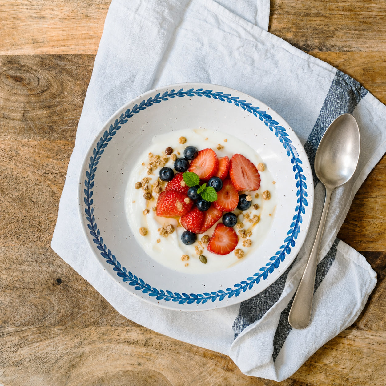 Handmade stoneware breakfast bowl styled with yoghurt, fruit and granola.