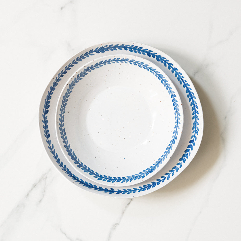 Stack of handmade Indigo Vine stoneware breakfast bowl and pasta bowl.