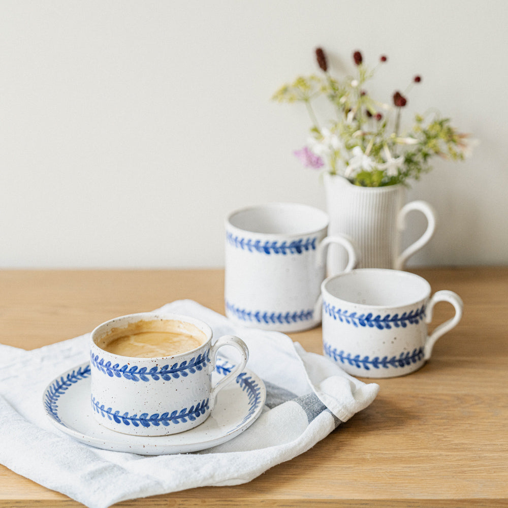 Handmade stoneware coffee cup styled as part of a relaxed breakfast setting