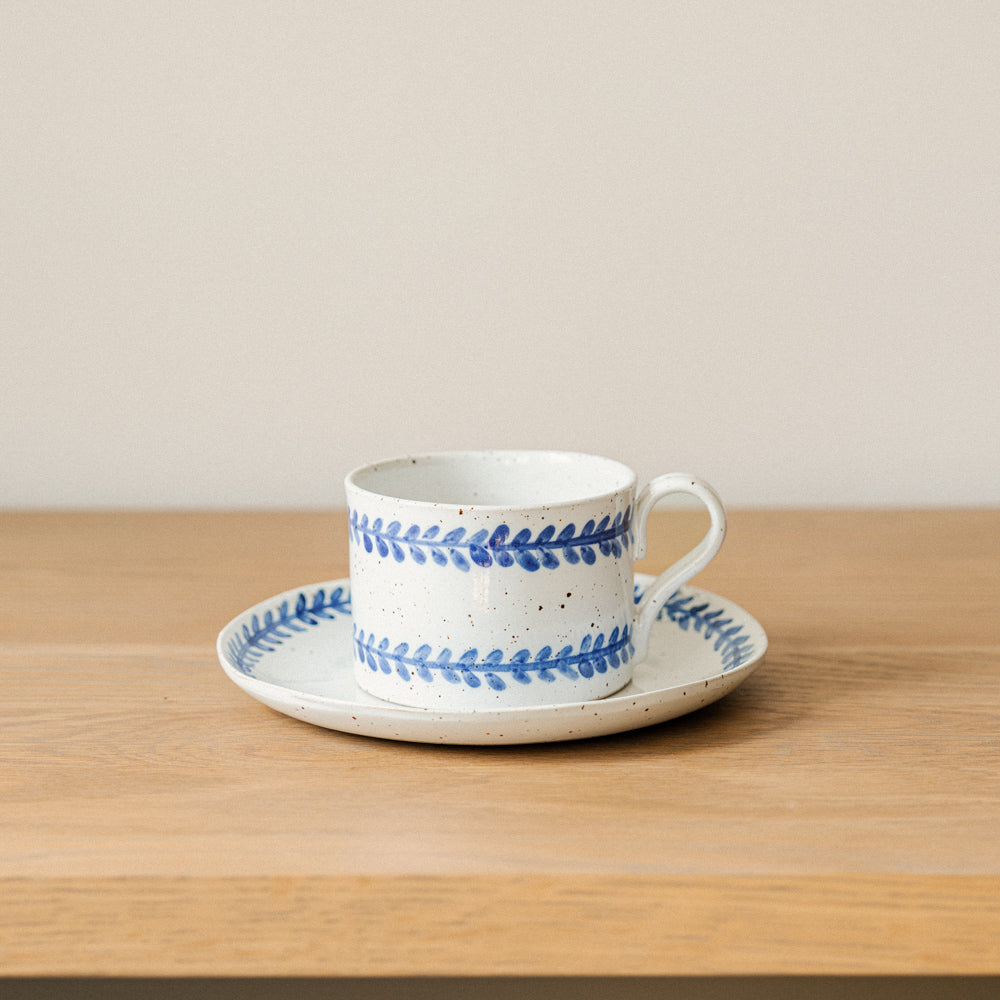 Handmade stoneware coffee cup styled as part of a relaxed breakfast setting